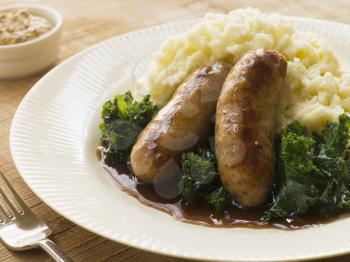 Royalty Free Photo of Pork Sausage and Mash with Curly Kale