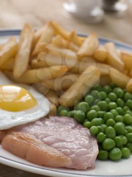 Royalty Free Photo of Gammon Steak Fried Egg Peas and Chips