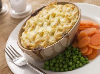 Royalty Free Photo of Individual Cottage Pie with Peas and Carrots