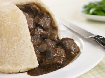 Royalty Free Photo of Steamed Steak and Kidney Pudding With Green Beans