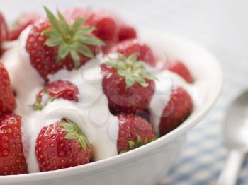 Royalty Free Photo of a Bowl of Strawberries and Cream