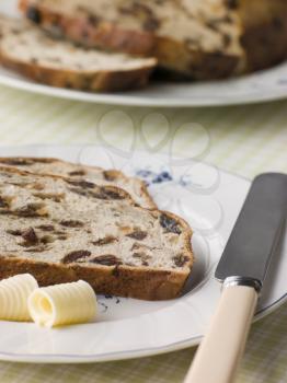 Royalty Free Photo of a Slice of Barm Brack with Butter