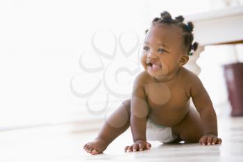 Royalty Free Photo of a Baby Crawling on the Floor