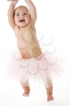 Royalty Free Photo of a Baby Standing in a Tutu