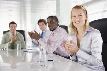 Royalty Free Photo of Four People Clapping in a Boardroom