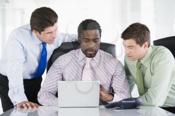 Royalty Free Photo of Three Businesspeople at a Laptop