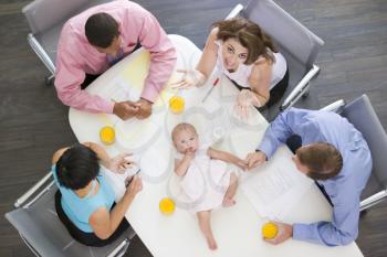 Royalty Free Photo of People and a Baby in a Boardroom