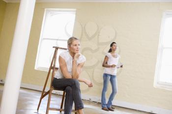 Royalty Free Photo of Two Women in an Empty Room