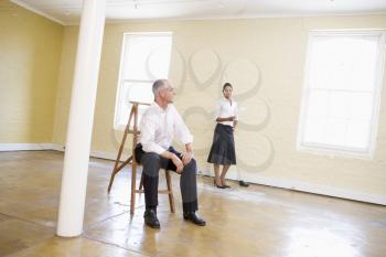 Royalty Free Photo of a Man and Woman in an Empty Room