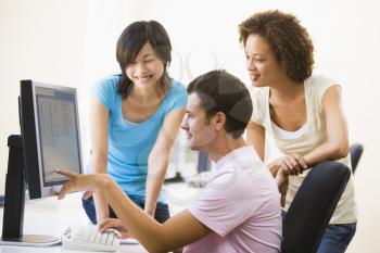 Royalty Free Photo of Three People at a Computer