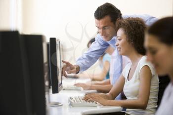Royalty Free Photo of a Man Helping a Woman at a Computer