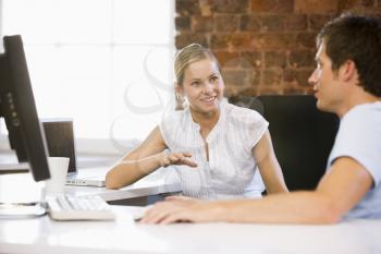 Royalty Free Photo of Two People Talking in an Office