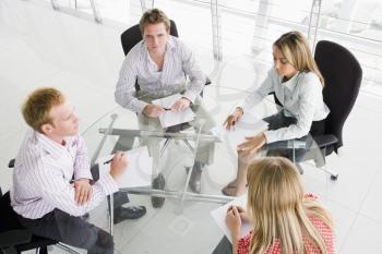 Royalty Free Photo of Four People Around a Boardroom Table