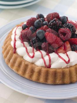 Royalty Free Photo of a Whipped Cream and Berry Sponge Flan