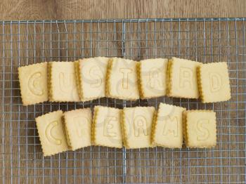 Royalty Free Photo of Custard Cream Biscuits on a Cooling Rack