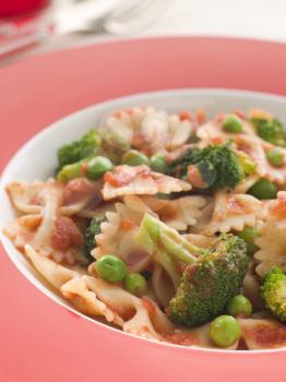 Royalty Free Photo of Pasta Bows with Tomato Sauce Broccoli and Peas