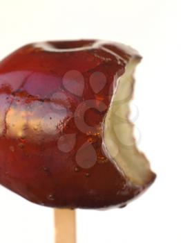 Royalty Free Photo of a Toffee Apple With a Bite Taken