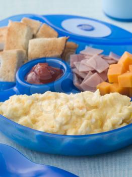 Royalty Free Photo of Scrambled Eggs With Toast Ham and Cheese Squares