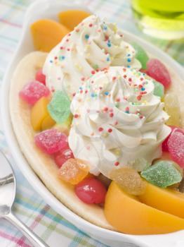 Royalty Free Photo of a Banana Split With Peaches and Whipped Ice Cream