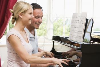 Royalty Free Photo of a Couple Playing Piano