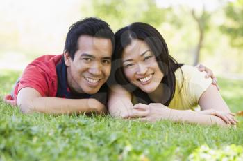 Royalty Free Photo of a Couple Lying on the Grass
