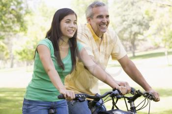 Royalty Free Photo of a Man and a Girl on Bikes