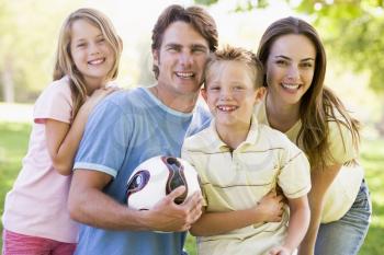Royalty Free Photo of a Family Outside With a Ball