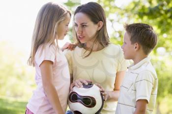 Royalty Free Photo of a Woman and Two Children With a Ball