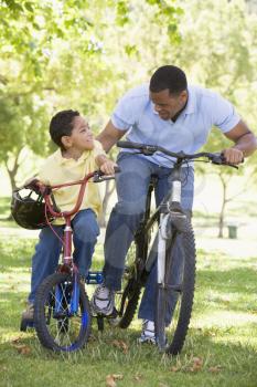 Royalty Free Photo of a Man and Boy Cycling
