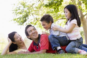 Royalty Free Photo of a Family Lying on the Grass