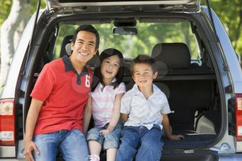 Royalty Free Photo of a Man With Two Children in a Hatchback