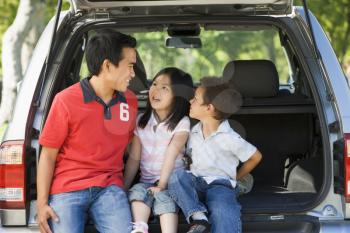 Royalty Free Photo of a Man and Two Children in a Hatchback