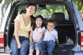 Royalty Free Photo of a Woman in a Hatchback With Two Children