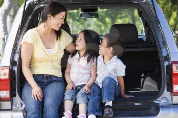 Royalty Free Photo of a Woman in a Hatchback With Two Children
