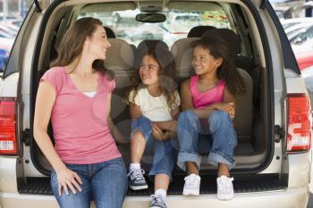 Royalty Free Photo of a Woman With Two Girls at a Hatchback
