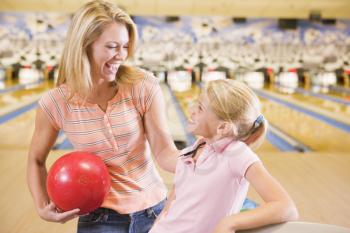 Royalty Free Photo of a Woman and Girl at the Bowling Alley