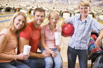 Royalty Free Photo of a Family With Drinks at a Bowling Alley