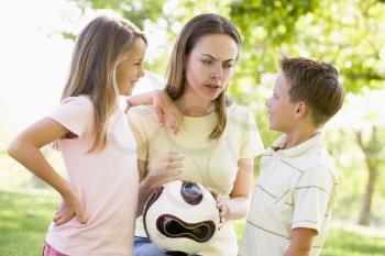 Royalty Free Photo of a Mother and Children With a Ball