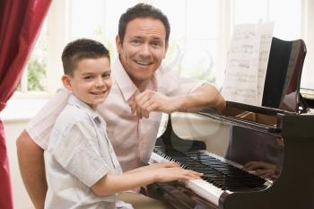 Royalty Free Photo of a Man and a Boy at a Piano