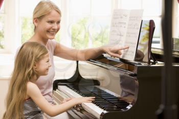 Royalty Free Photo of a Woman and Girl at the Piano