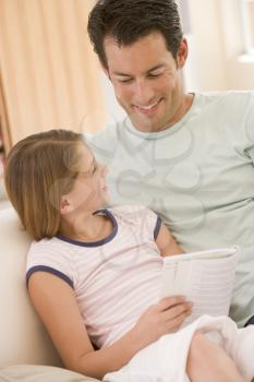 Royalty Free Photo of a Man and His Daughter on the Couch