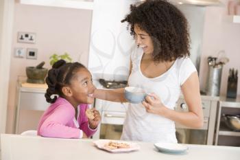 Royalty Free Photo of a Woman and Daughter in the Kitchen