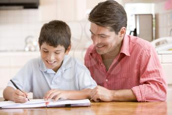 Royalty Free Photo of a Guy Helping His Son With Homework