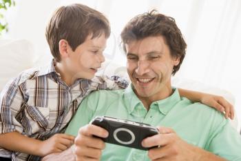 Royalty Free Photo of a Father and Son With a Video Game Controller