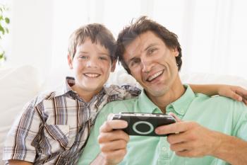 Royalty Free Photo of a Man and Boy With a Video Game Controller