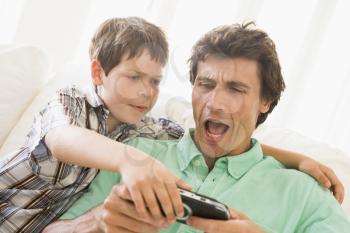 Royalty Free Photo of a Man and a Boy Playing Video Games