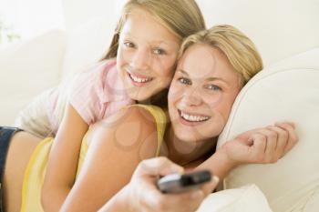 Royalty Free Photo of a Woman and Little Girl With a Remote
