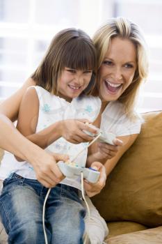 Royalty Free Photo of a Mother and Daughter Playing Video Games