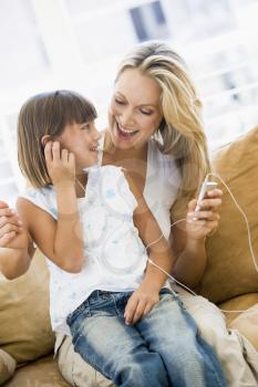 Royalty Free Photo of a Mother and Daughter With an MP3 Player