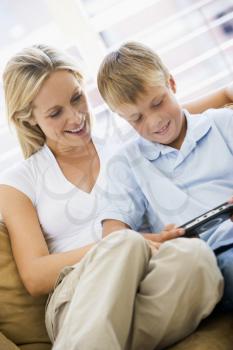 Royalty Free Photo of a Mother and Son With a Video Controller